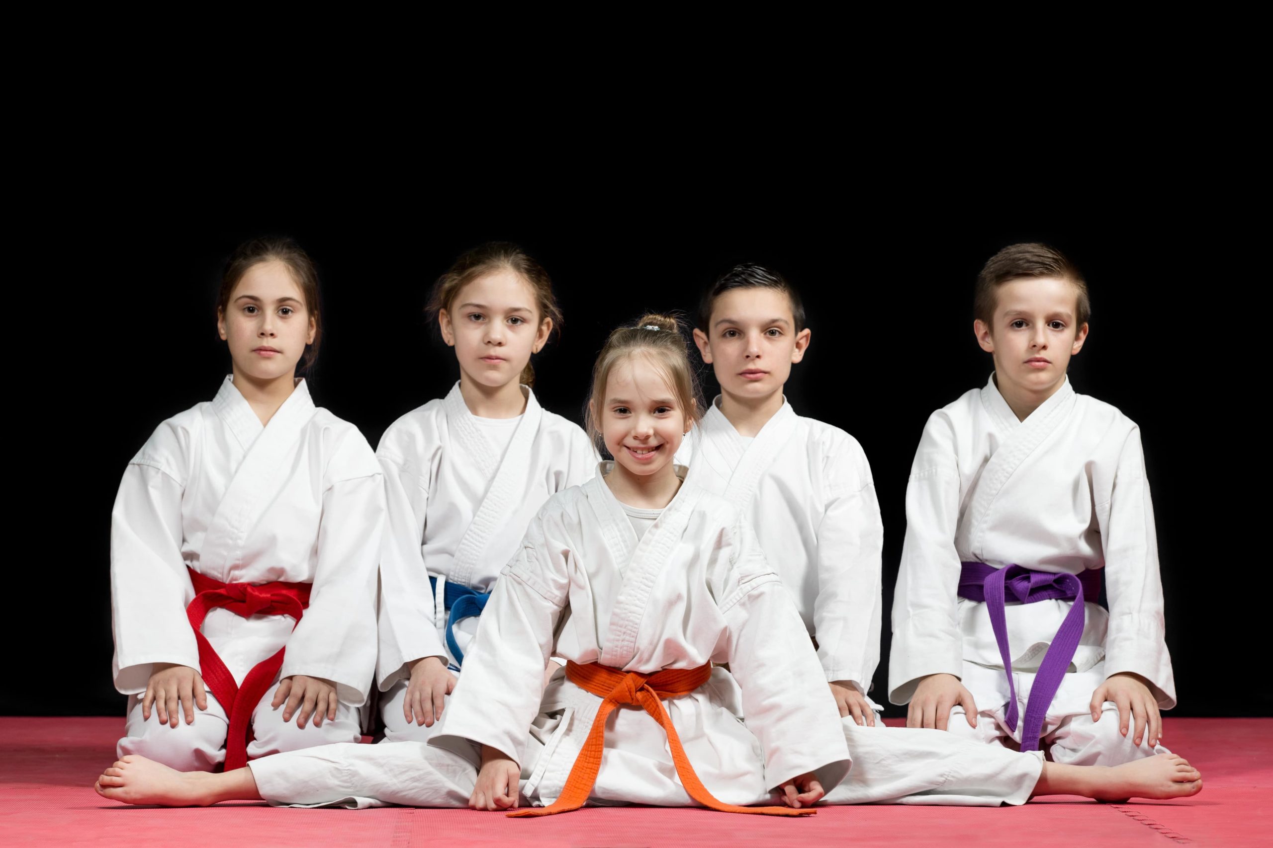 smiling kids in karate uniforms